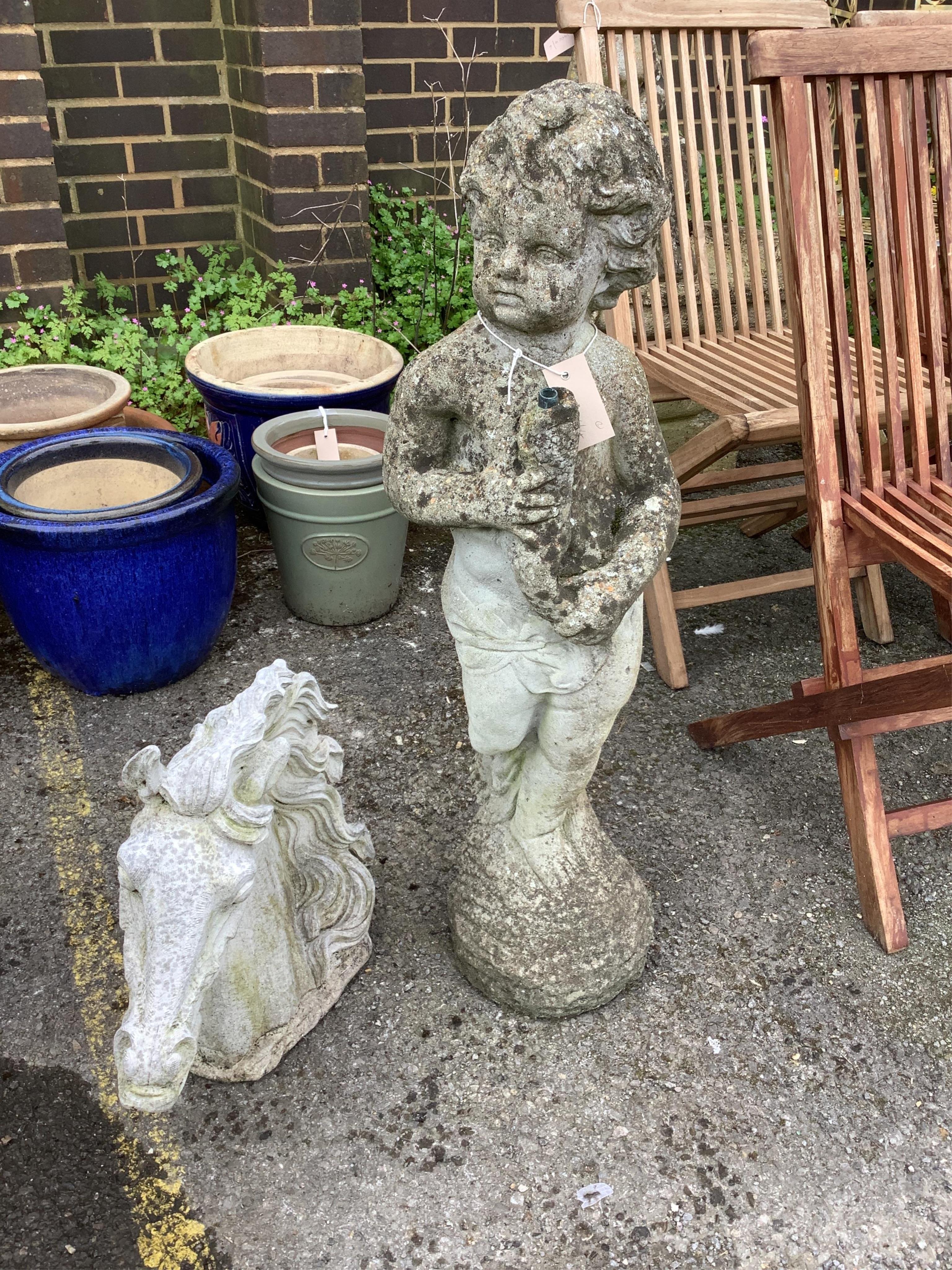 A reconstituted stone cherub garden fountain, height 88cm and a stone horse head garden ornament